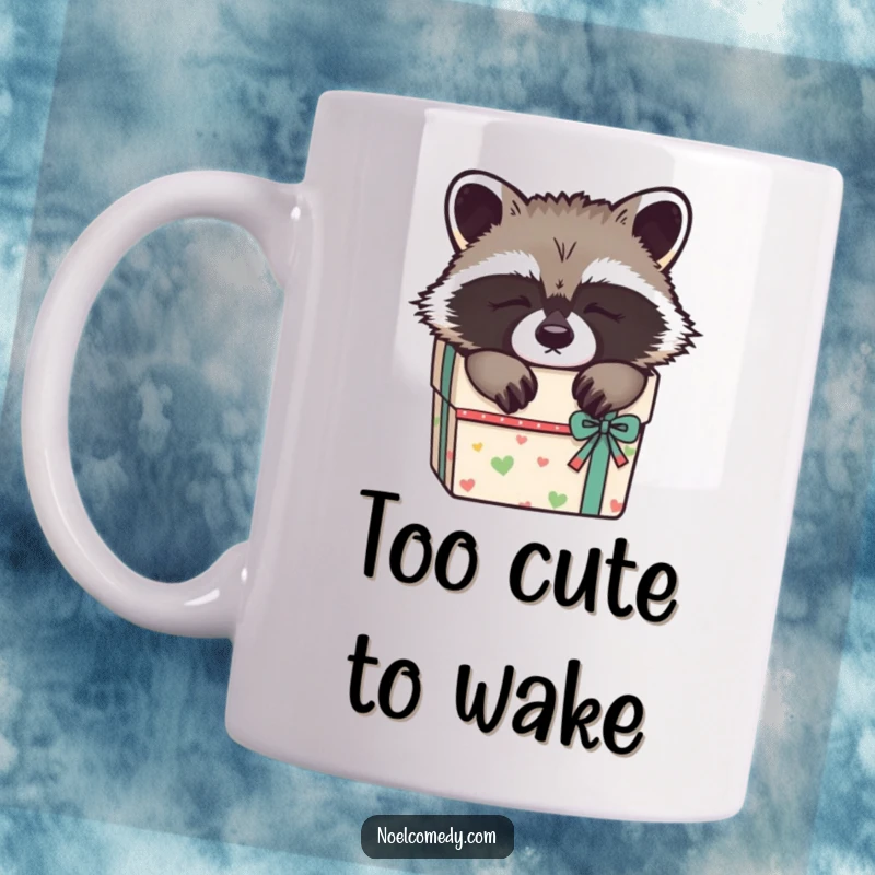 Funny Sleepy Raccoon Mug: A cute raccoon snoozing peacefully inside a beautifully wrapped gift box, evoking cozy charm.