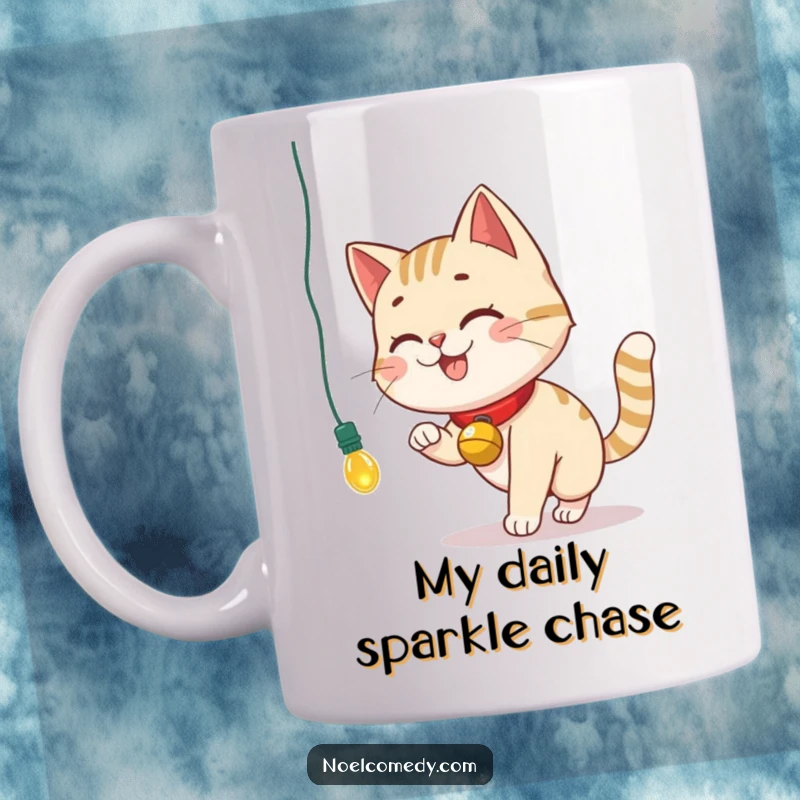 Funny Mug featuring a smiling cat with a bell collar, playfully chasing a dangling Christmas light.