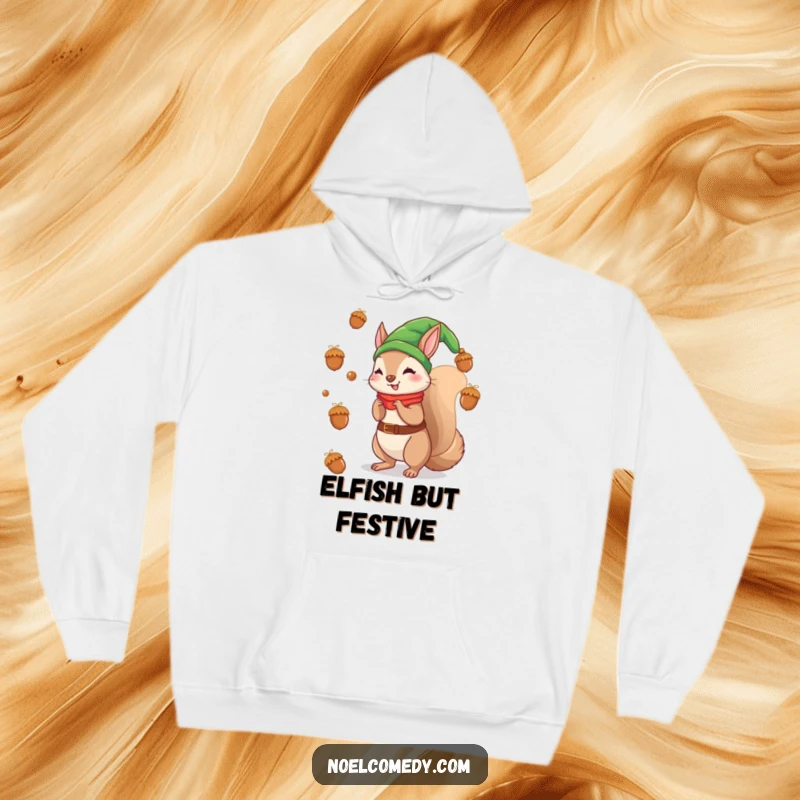 Funny hoodie featuring a squirrel elf playfully tossing acorns like festive ornaments, ideal for winter.