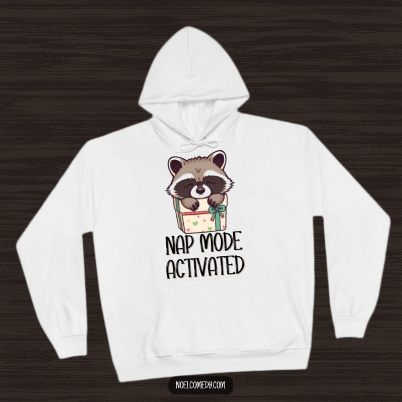 Funny Sleepy Raccoon Hoodie: A soft hoodie depicting a raccoon napping in a gift box, offering warmth and cute humor.